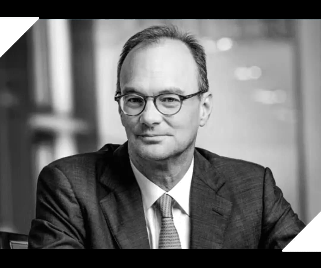 Black and white portrait of a man with glasses in a suit, HOMEBOX governance team member