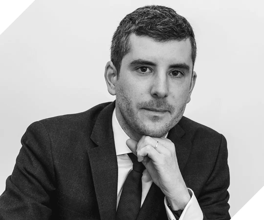 Black and white portrait of a man in a suit and tie, HOMEBOX governance team member