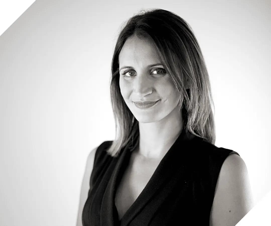 Black and white portrait of a smiling woman in a black sleeveless top, HOMEBOX team member